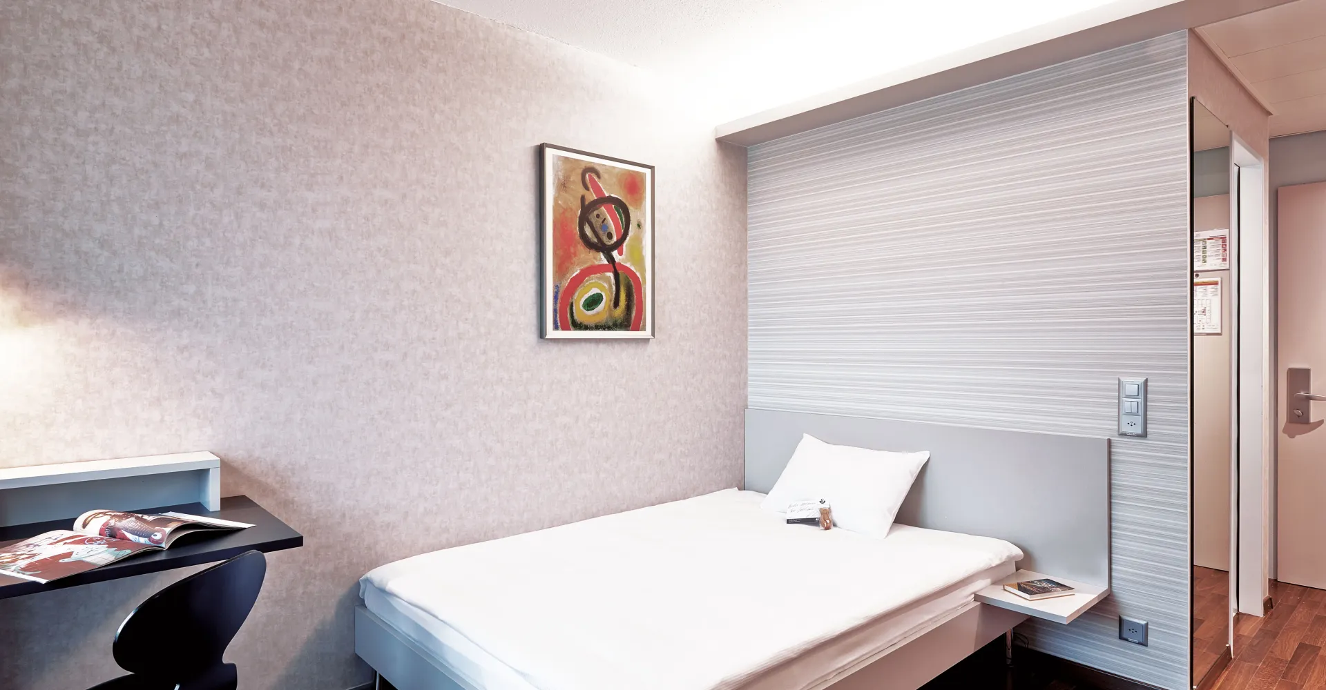 Standard room with bed and sitting area at Hotel Ador